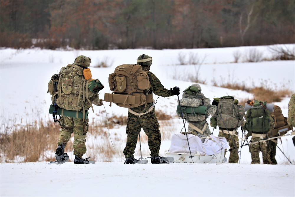 Fort McCoy Cold-Weather Operations Course students train in snowshoes pulling ahkio sled