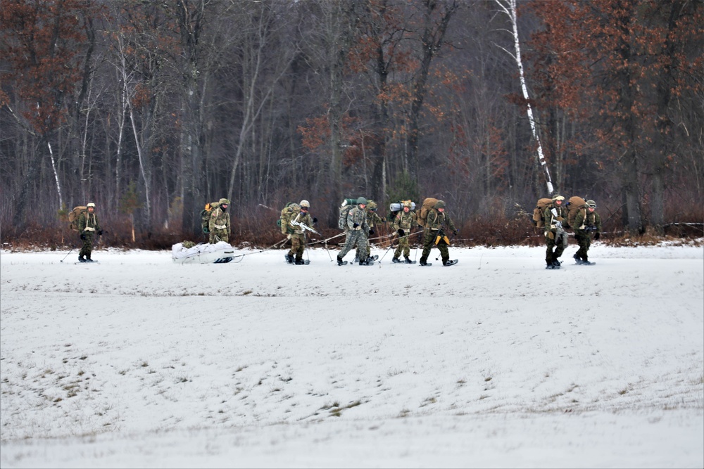 Fort McCoy Cold-Weather Operations Course students train in snowshoes pulling ahkio sled