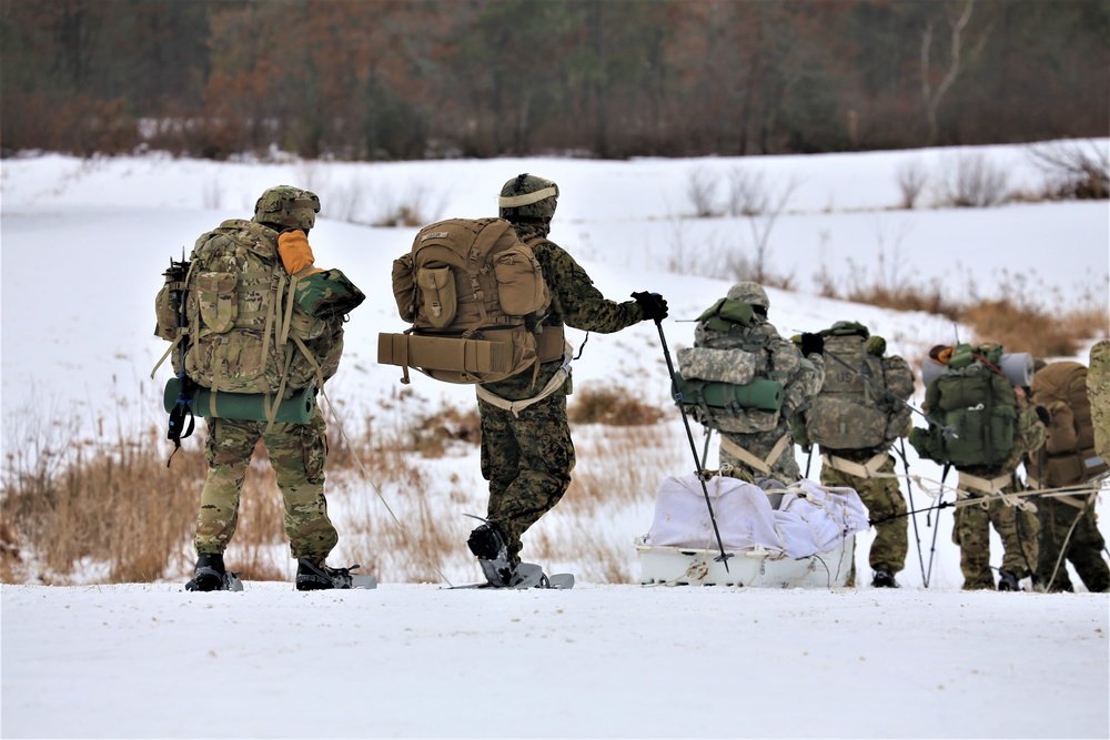 Fort McCoy Cold-Weather Operations Course students train in snowshoes pulling ahkio sled