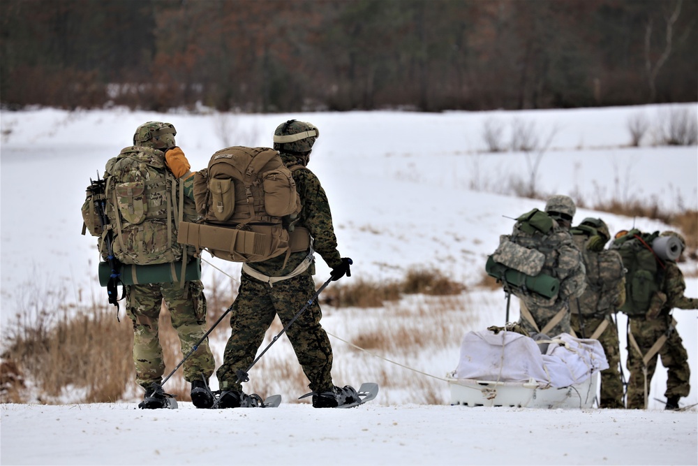 Fort McCoy Cold-Weather Operations Course students train in snowshoes pulling ahkio sled