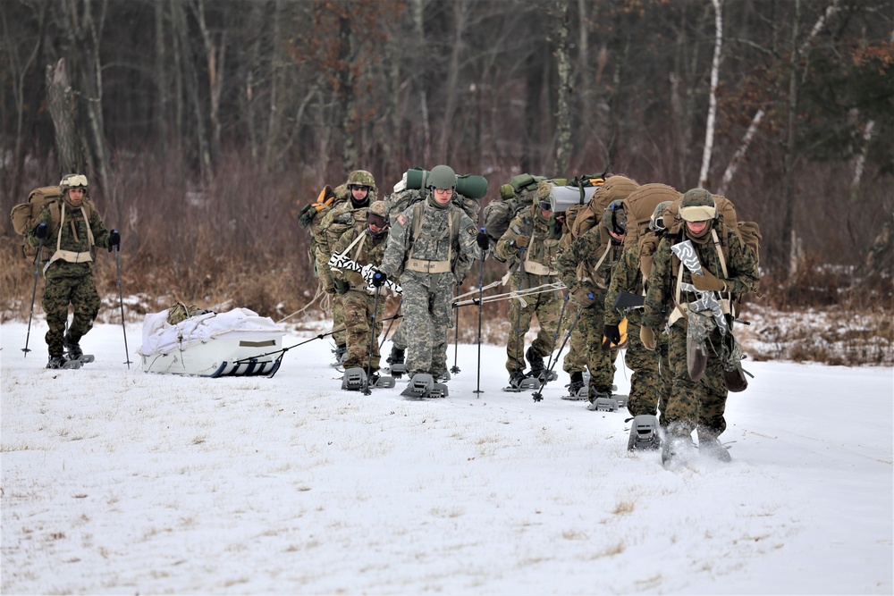 Fort McCoy Cold-Weather Operations Course students train in snowshoes pulling ahkio sled