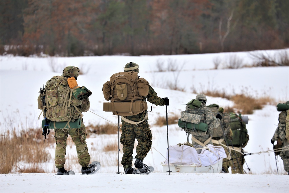 Fort McCoy Cold-Weather Operations Course students train in snowshoes pulling ahkio sled