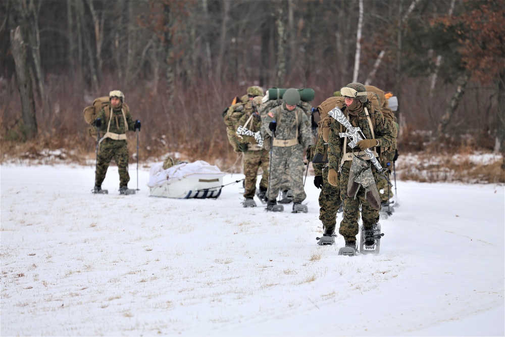 Fort McCoy Cold-Weather Operations Course students train in snowshoes pulling ahkio sled