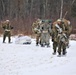 Fort McCoy Cold-Weather Operations Course students train in snowshoes pulling ahkio sled