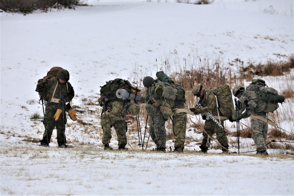 Fort McCoy Cold-Weather Operations Course students train in snowshoes pulling ahkio sled