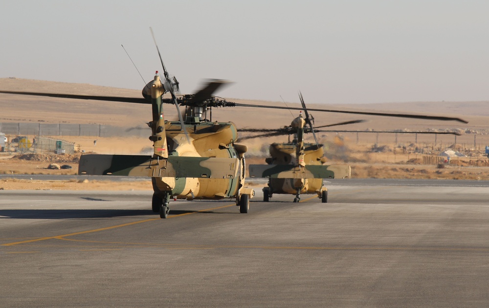 Royal Jordanian Air Force helicopters leave King Abdullah II Air Base with US soldiers
