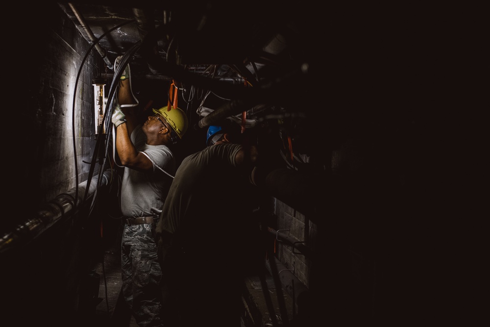 Airmen assigned to the 205th Engineering and Installation Squadron (205th EIS) at Will Rogers Air National Guard Base in Oklahoma City, install fiber optic cables underneath Wyoming Air National Guard Base in Cheyenne, Wyo.