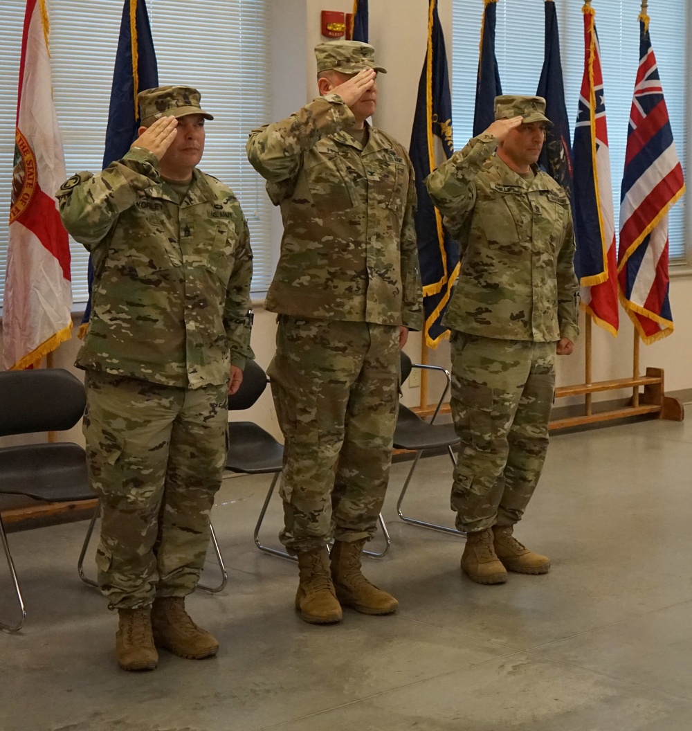 55th Maneuver Enhancement Brigade Command Sgt. Major passes the colors to the next Command Sgt. Major
