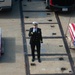 U.S. Sailor shouts to raise a casket from the pier to the aircraft carrier USS John C. Stennis (CVN 74)