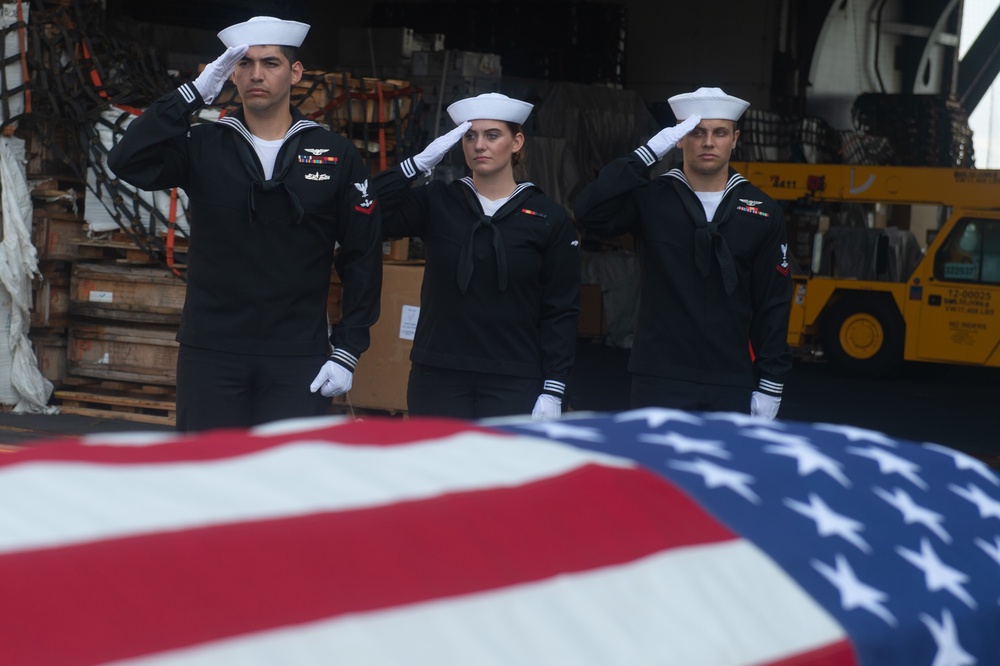 Sailors participate in a burial-at-sea