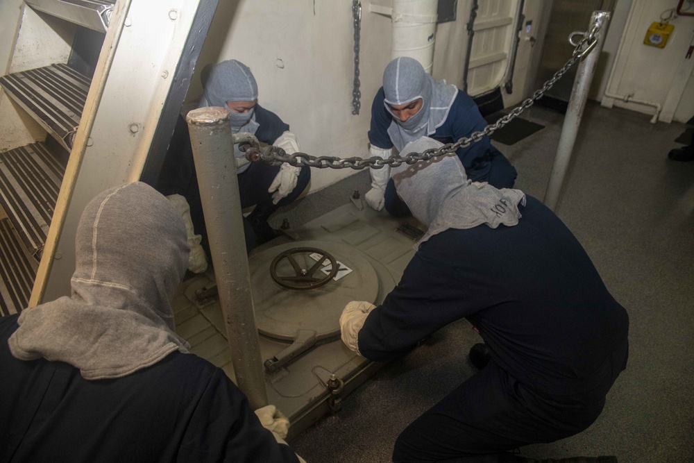 Sailors dog down a hatch