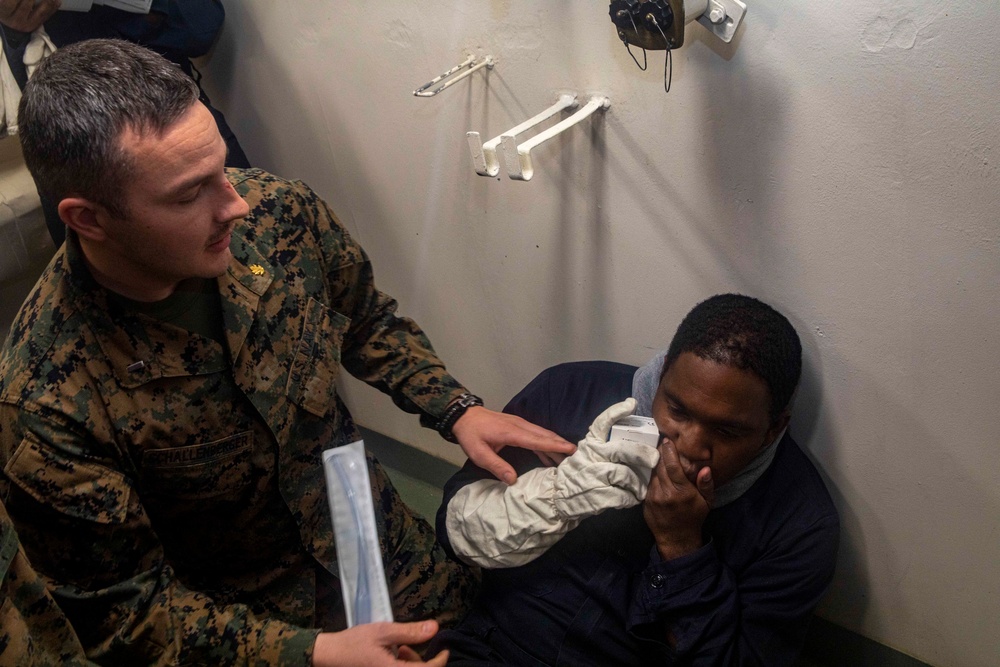 Sailor attends to simulated casaulty