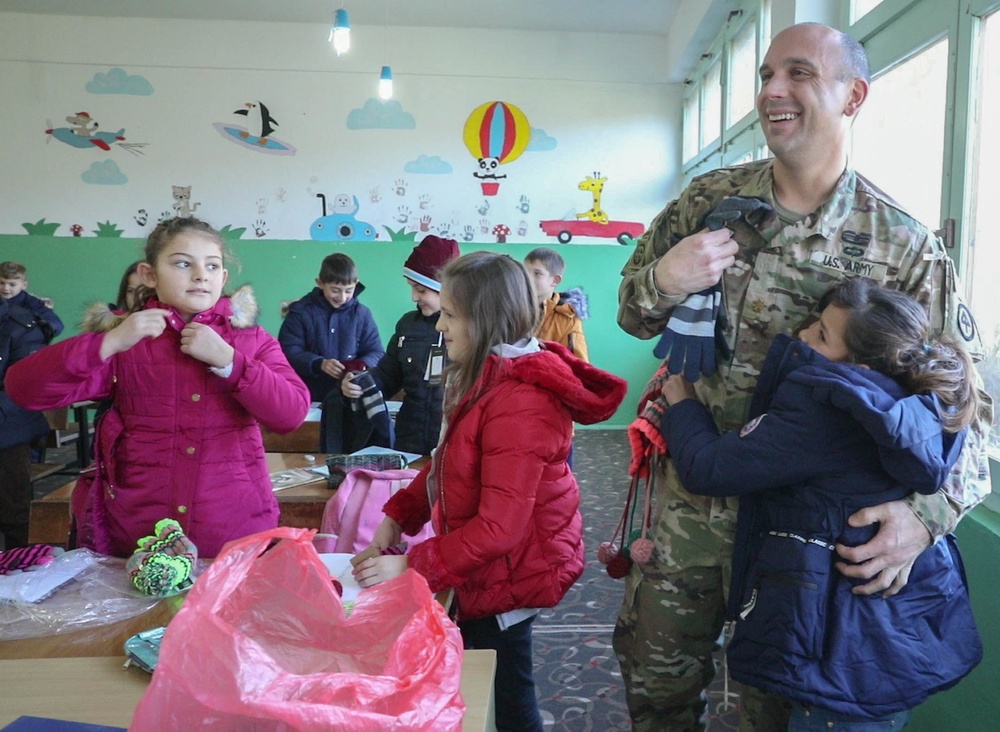 KFOR Soldiers keep students warm in winter
