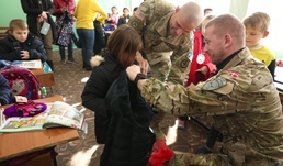 KFOR Soldiers keep students warm in winter
