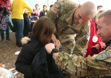 KFOR Soldiers keep students warm in winter