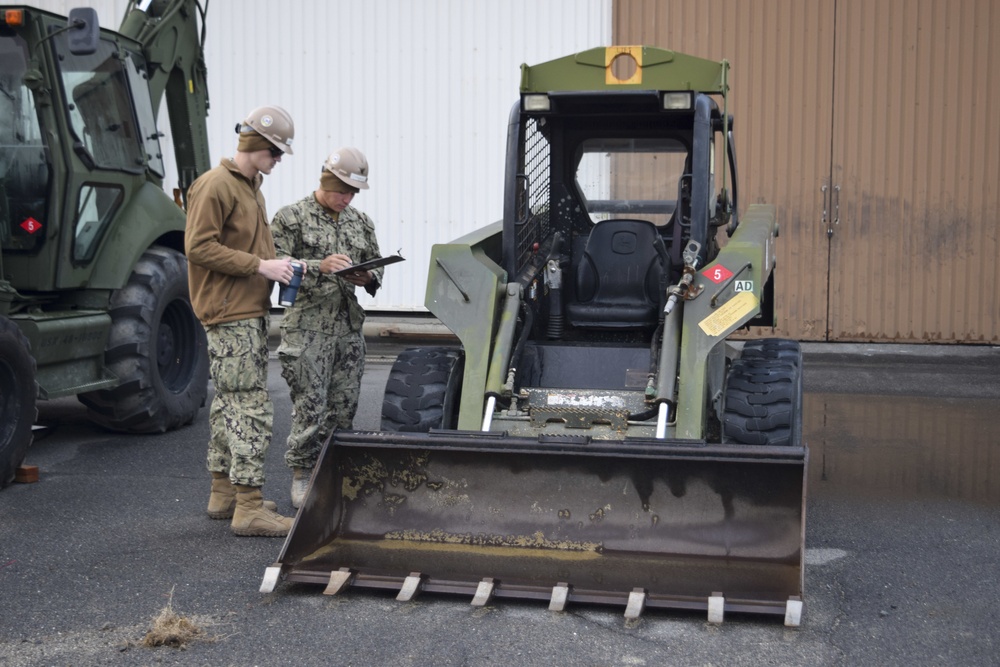 U.S. Navy Seabees deployed with NMCB-5’s Detail Iwakuni inspect equipment