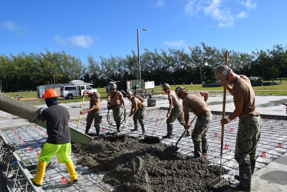 U.S. Navy Seabees from NMCB 5’s Detail Diego Garcia place concrete in support of the U.S. Air Force