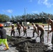 U.S. Navy Seabees from NMCB 5’s Detail Diego Garcia place concrete in support of the U.S. Air Force