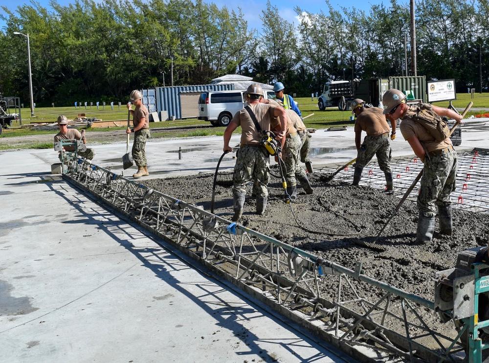 U.S. Navy Seabees from NMCB 5’s Detail Diego Garcia place concrete in support of the U.S. Air Force