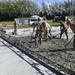 U.S. Navy Seabees from NMCB 5’s Detail Diego Garcia place concrete in support of the U.S. Air Force