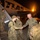 U.S. Army soldiers are arriving or departing via an Atlas Air aircraft at night, with personnel greeting each other on the tarmac. A senior officer in U.S. Army uniform is shaking hands and welcoming soldiers as they descend the aircraft stairs. The scene appears to be a military deployment arrival or redeployment homecoming event.