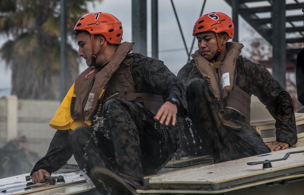 Assault Amphibian School students take a ride in the Submerged Vehicle Egress Trainer