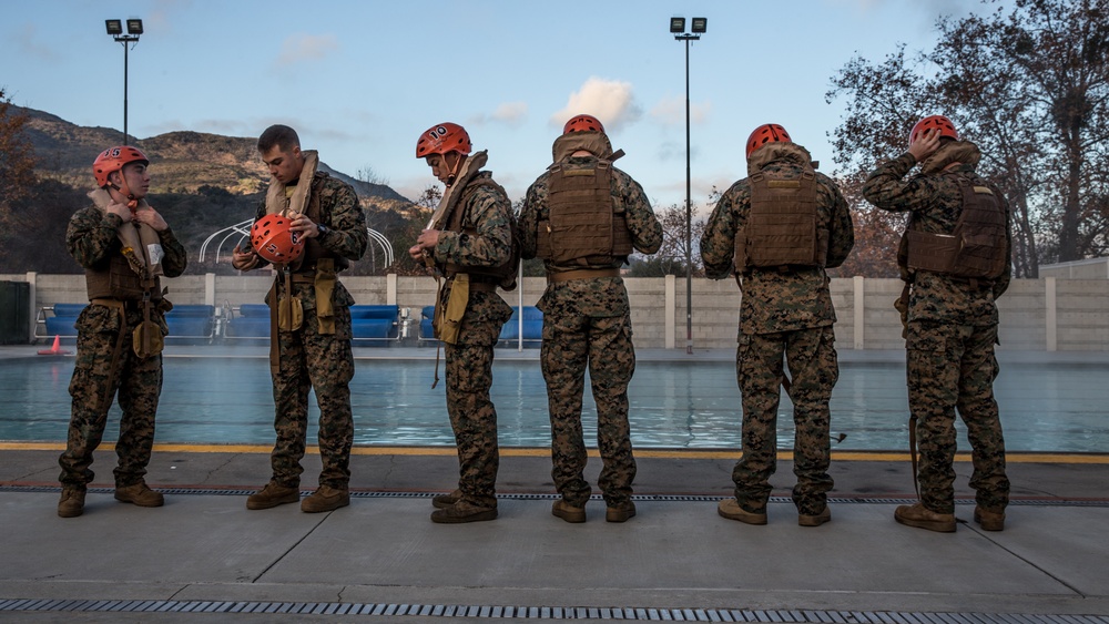 Assault Amphibian School students take a ride in the Submerged Vehicle Egress Trainer