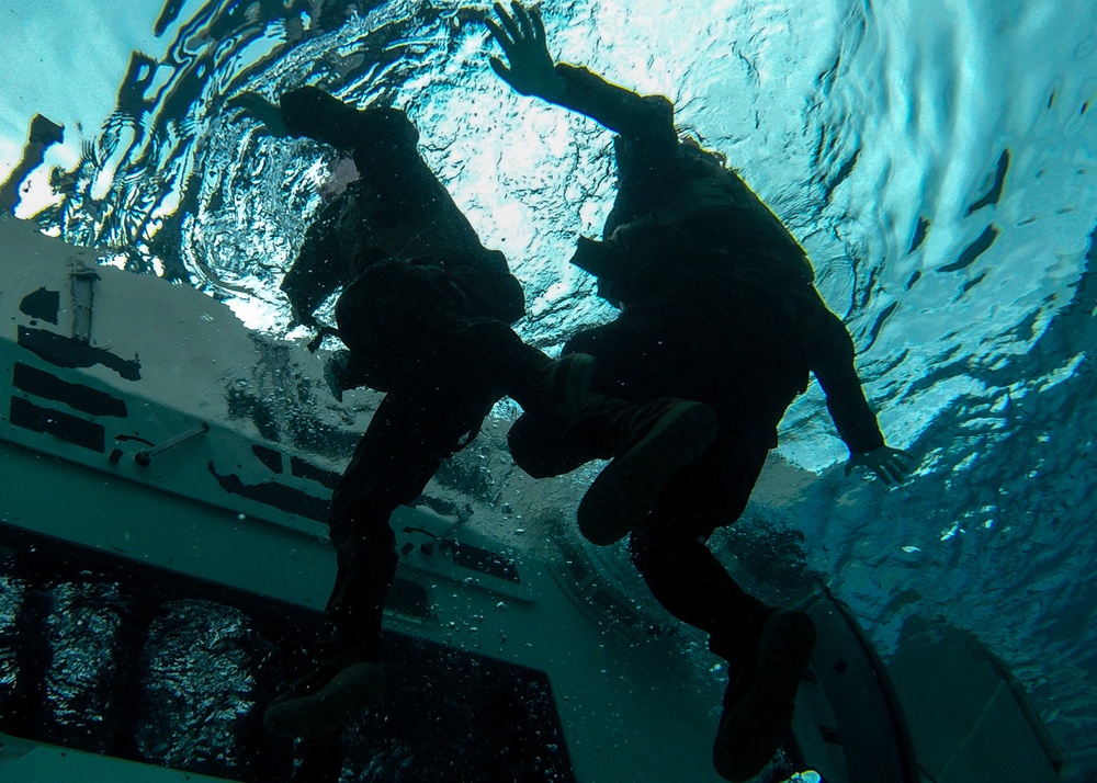 Assault Amphibian School students take a ride in the Submerged Vehicle Egress Trainer