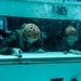 Assault Amphibian School students take a ride in the Submerged Vehicle Egress Trainer