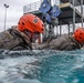 Assault Amphibian School students take a ride in the Submerged Vehicle Egress Trainer