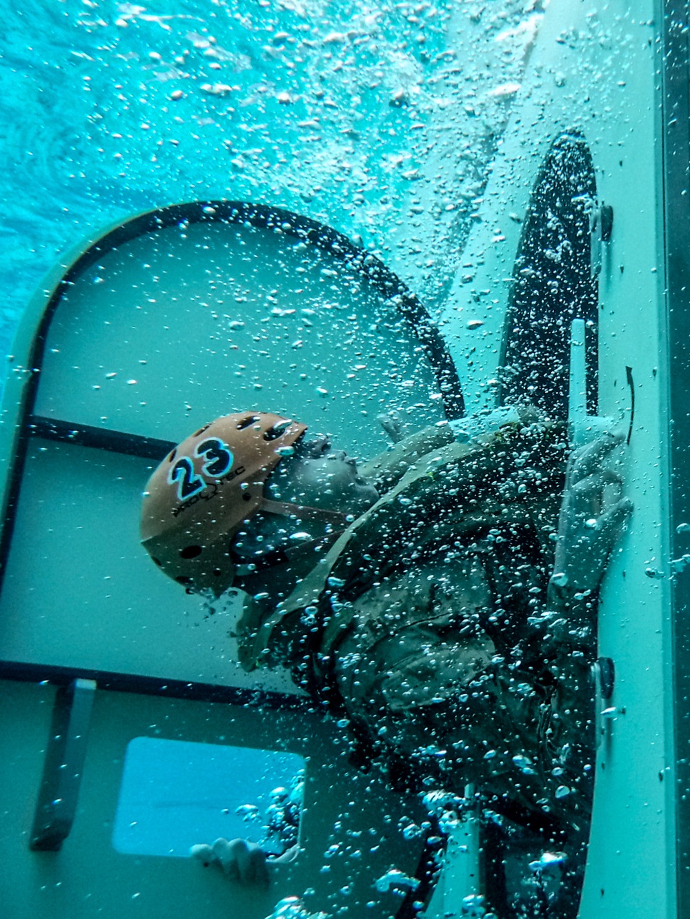 Assault Amphibian School students take a ride in the Submerged Vehicle Egress Trainer