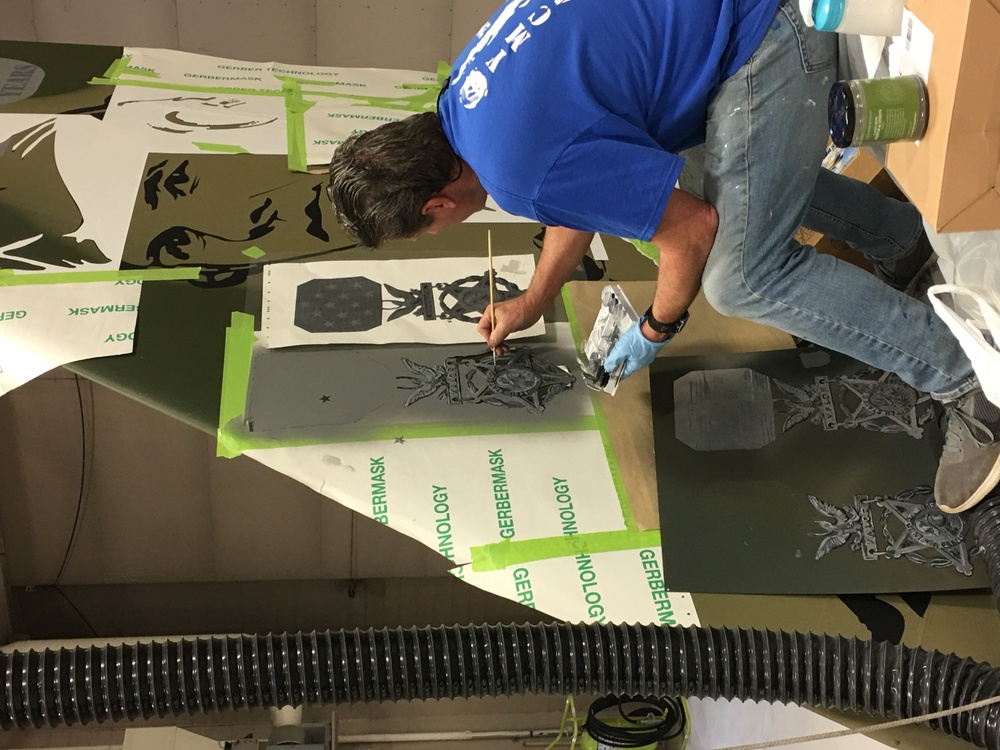 Local artist adds finishing touches to new wing flagship