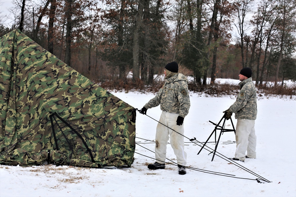 Cold-Weather Operations Course Class 20-01 students build Arctic tents during training at Fort McCoy