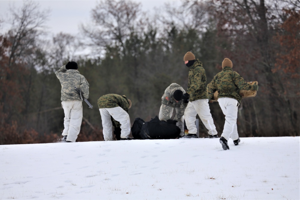 Cold-Weather Operations Course Class 20-01 students build Arctic tents during training at Fort McCoy