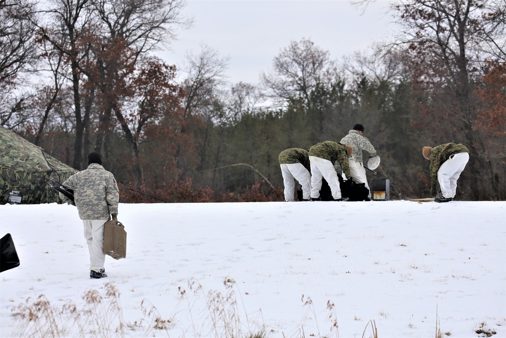 Cold-Weather Operations Course Class 20-01 students build Arctic tents during training at Fort McCoy