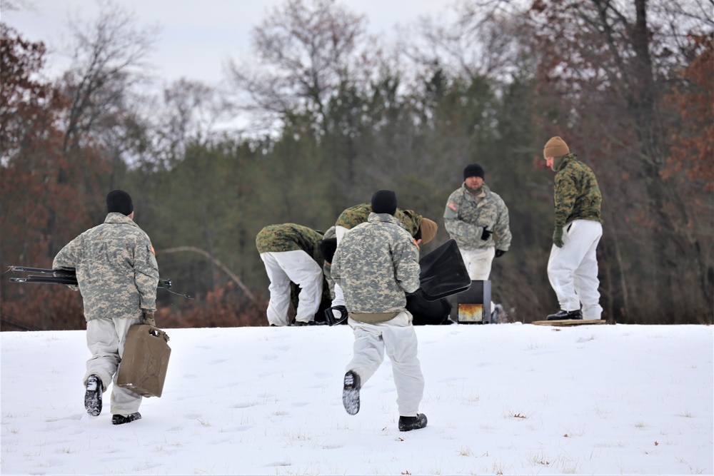 Cold-Weather Operations Course Class 20-01 students build Arctic tents during training at Fort McCoy