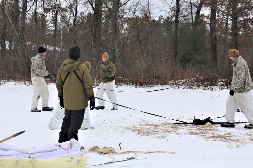 Cold-Weather Operations Course Class 20-01 students build Arctic tents during training at Fort McCoy