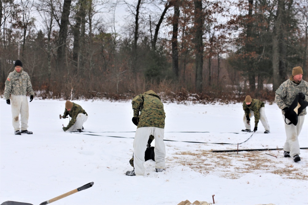 Cold-Weather Operations Course Class 20-01 students build Arctic tents during training at Fort McCoy