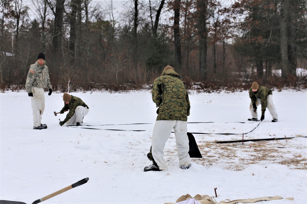 Cold-Weather Operations Course Class 20-01 students build Arctic tents during training at Fort McCoy