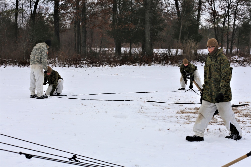 Cold-Weather Operations Course Class 20-01 students build Arctic tents during training at Fort McCoy
