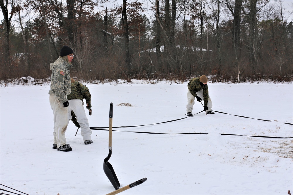 Cold-Weather Operations Course Class 20-01 students build Arctic tents during training at Fort McCoy