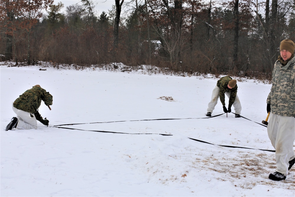 Cold-Weather Operations Course Class 20-01 students build Arctic tents during training at Fort McCoy