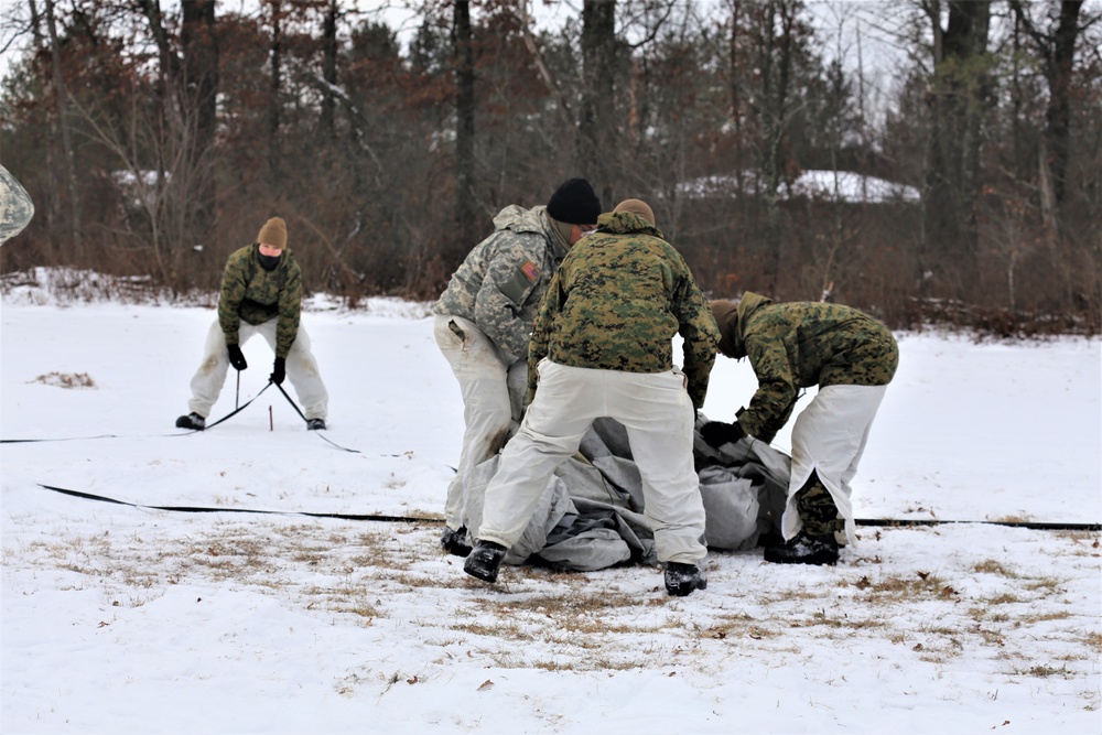 Cold-Weather Operations Course Class 20-01 students build Arctic tents during training at Fort McCoy