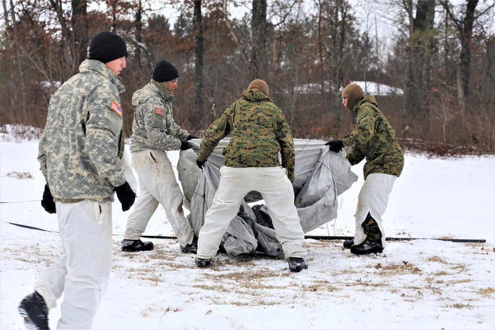Cold-Weather Operations Course Class 20-01 students build Arctic tents during training at Fort McCoy