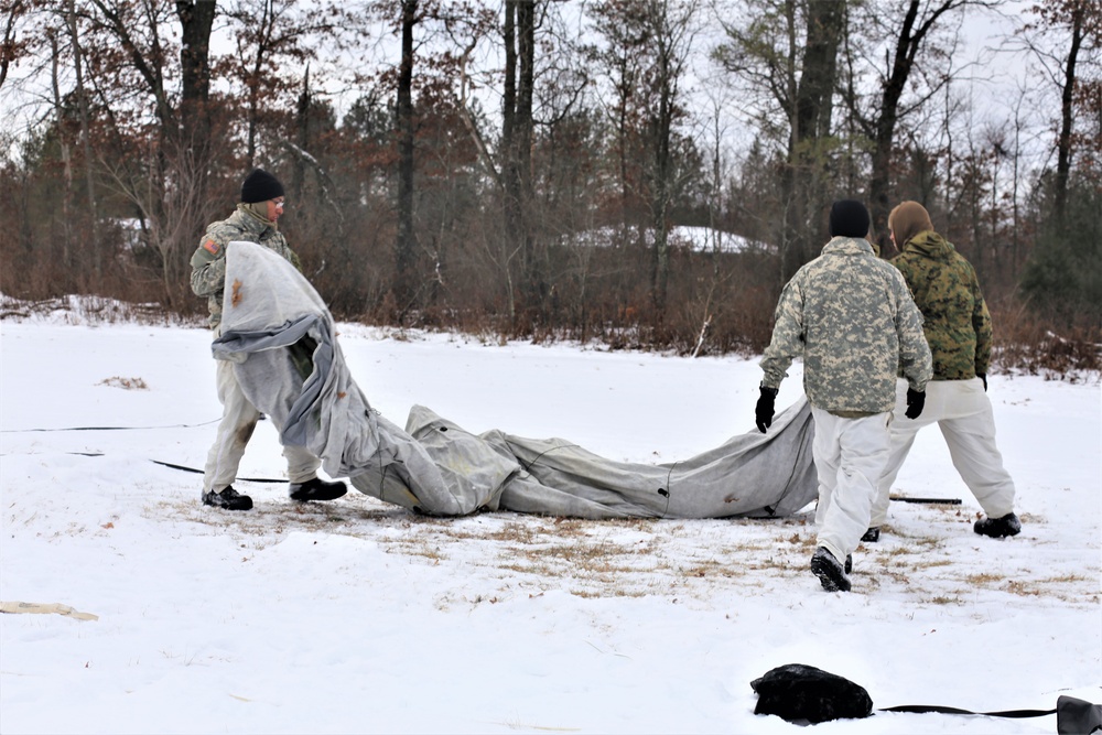 Cold-Weather Operations Course Class 20-01 students build Arctic tents during training at Fort McCoy