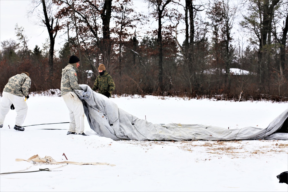 Cold-Weather Operations Course Class 20-01 students build Arctic tents during training at Fort McCoy