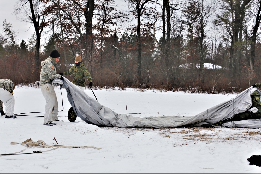 Cold-Weather Operations Course Class 20-01 students build Arctic tents during training at Fort McCoy