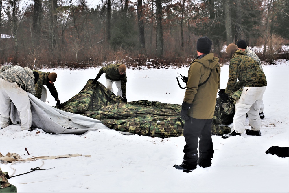 Cold-Weather Operations Course Class 20-01 students build Arctic tents during training at Fort McCoy