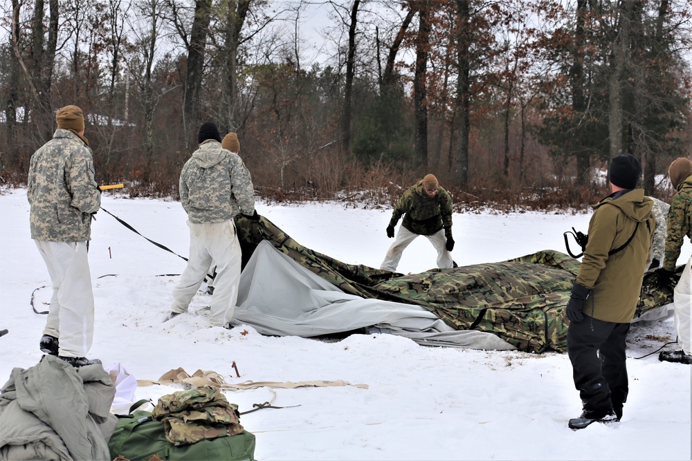 Cold-Weather Operations Course Class 20-01 students build Arctic tents during training at Fort McCoy
