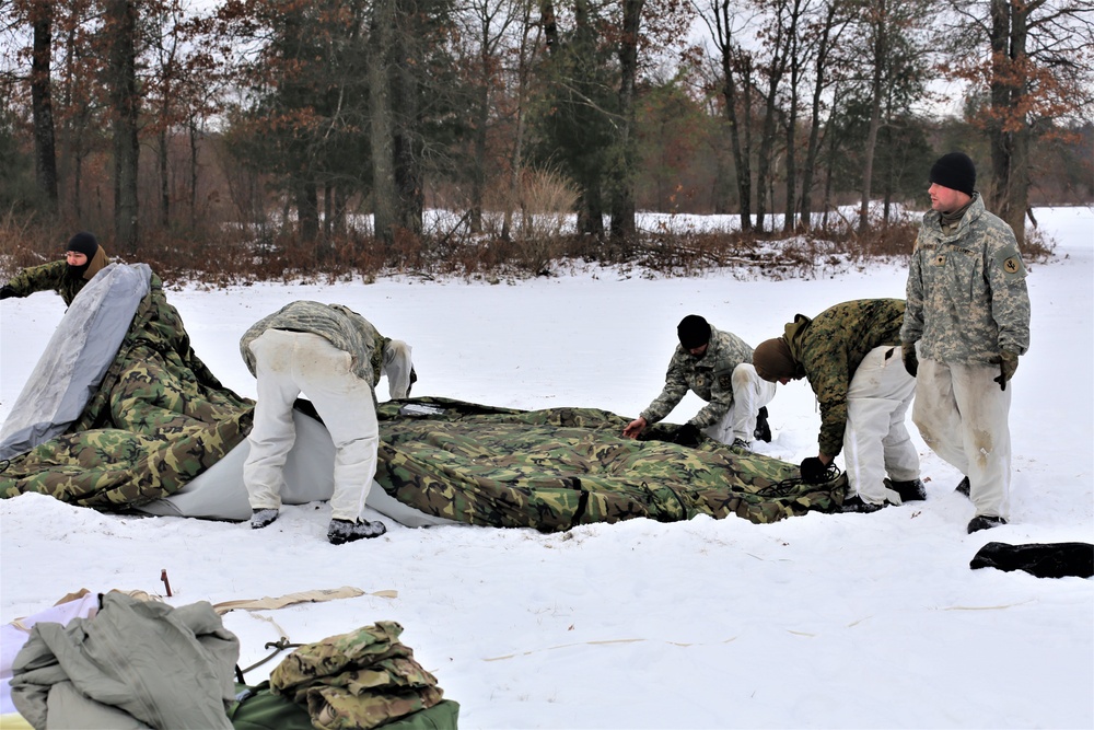 Cold-Weather Operations Course Class 20-01 students build Arctic tents during training at Fort McCoy